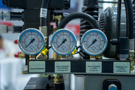Industrial pressure gauges with control labels on equipment