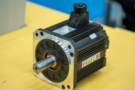 AC servo motor with mechanical shaft and control terminal on workbench