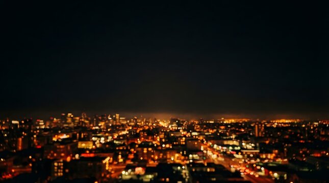 Aerial view of a brightly lit city at night with a dark sky above
