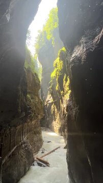 Sunlight Illuminating the Dramatic Partnach Gorge with Turquoise Mountain River in Garmisch-Partenkirchen, Bavaria, Germany