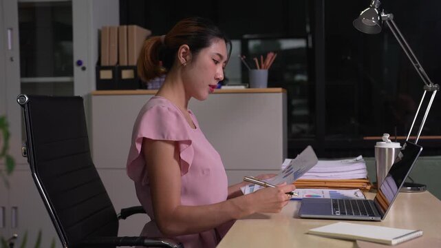 Business woman working on laptop and accounting financial report, accountant using calculator to calculate tax refund at office