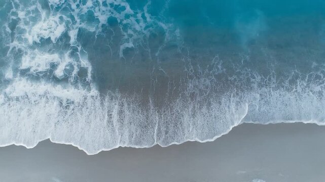 Overhead Shot of Turquoise Sea Waves Rolling Onto Shore