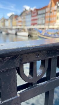 Nyhavn Canal Seen Past an Ornate Iron Railing