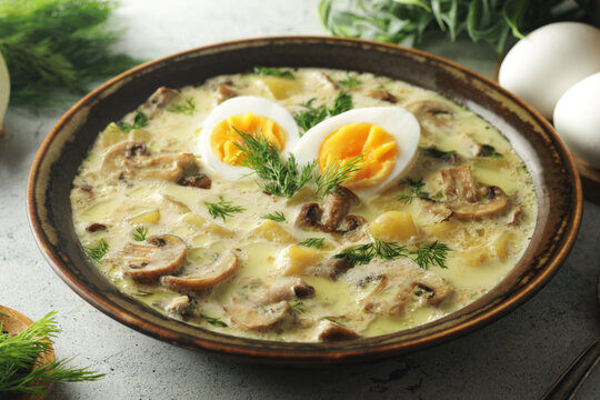 The rustic bowl with traditional Czech mushroom soup Kulajda	