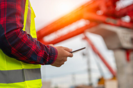 Engineer Using Mobile Tablet for Construction Inspection