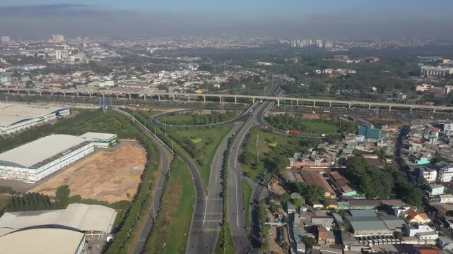 Aerial drone view of Tram 2 Interchange in Tang Nhon Phu Ward, Ho Chi Minh City, Vietnam, showing busy traffic at the intersection of National Highway 1A and the Eastern Ring Road.