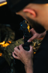 Naklejka premium Soldier adjusting night vision device before sunset