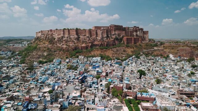 Jodhpur blue city aerial view showing mehrangarh fort towering above houses in rajasthan, india
