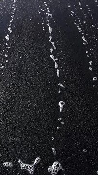 Ocean Foam Cresting and Receding in a Dynamic Looping Animation. Black and White Footage of Turbulent Water Movement.