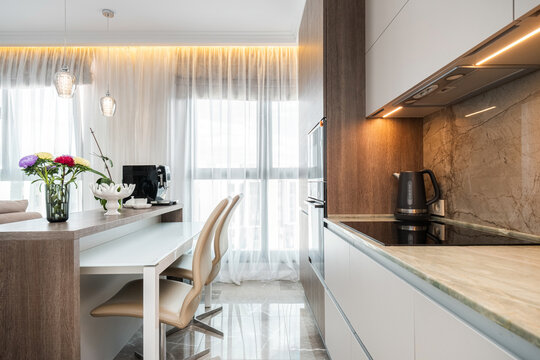 Kitchen island with dining table extension and marble splashback