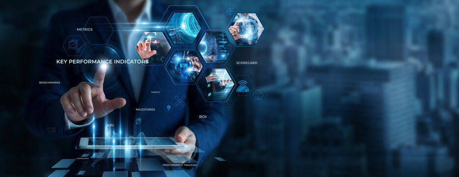 Businessman Using Tablet for Analyzing KPI Data. Monitoring business performance, measuring strategic goals, improving productivity, data driven management decisions.