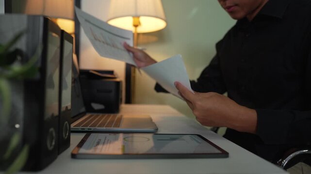 Businessmen are calculating income-expenditure and analyzing real estate investment data at office.