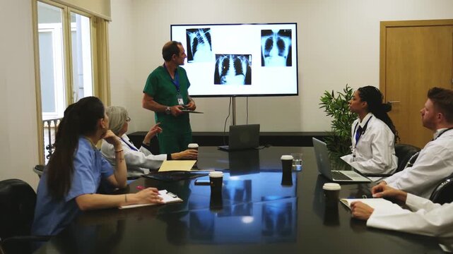 Medical team discussing a patient's lung radiography in a hospital conference room during a meeting