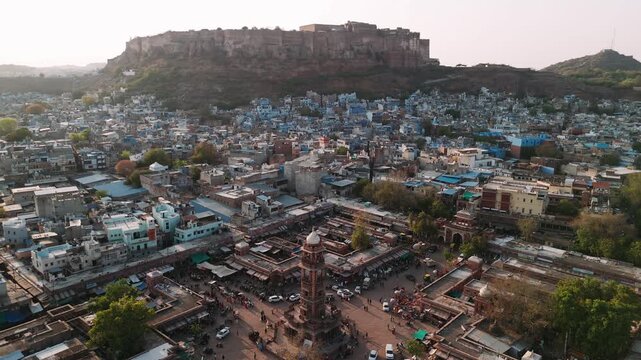 Aerial view of jodhpur blue city with mehrangarh fort and ghanta ghar clock tower at sunset in rajasthan, india