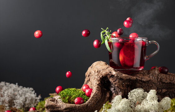 Hot drink with cranberries, lime, and rosemary.