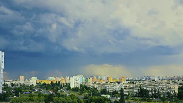 Dramatic Storm Clouds Over Modern Urban Cityscape with Colorful Buildings