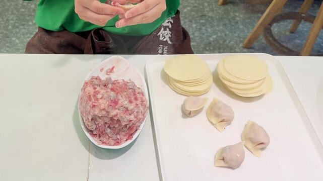 Hands Preparing Wontons and Dim Sum &ndash; Chinese Street Cafe Cooking