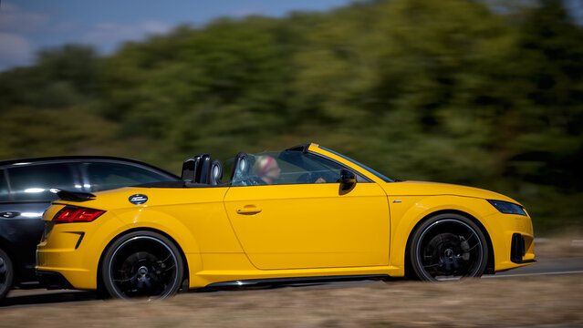 Milton Keynes; UK - Aug 23rd 2026:; 2019 yellow Audi tt convertiblecar driving on a British road
