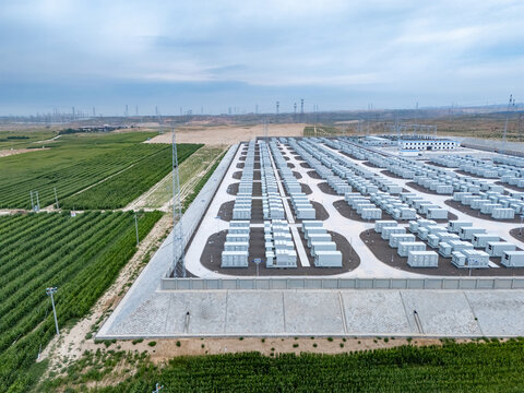Aerial view of large outdoor energy storage power station with rows of battery containers