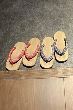 Japanese sandals lined up on wooden stand