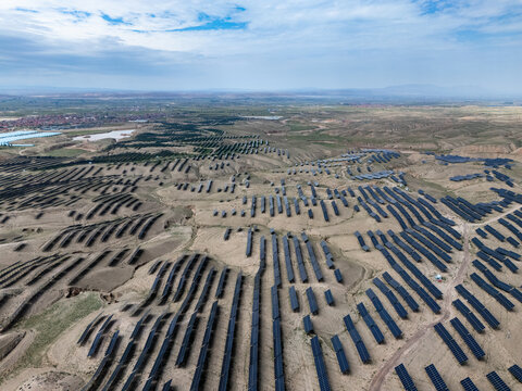 Aerial view of solar panels arranged in rows on the land