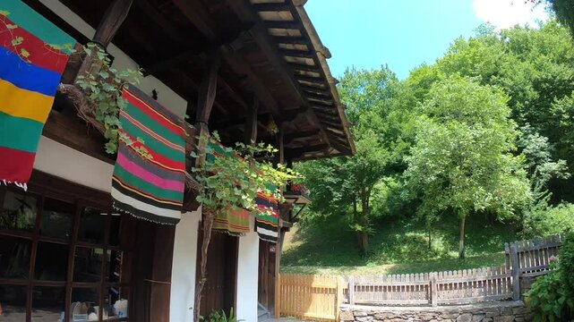 Traditional bulgarian house with colorful rugs in etar ethnographic museum