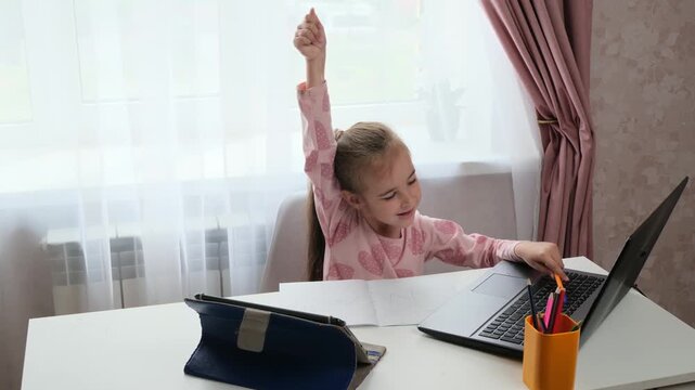 Happy student child finishing online class at home with success