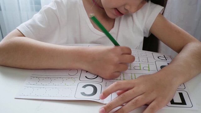 Child learning at home with paper and pencil concept