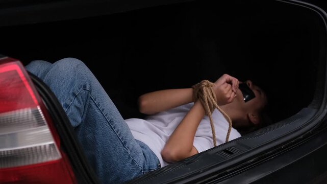 Staged Escape Training with Young Woman in Car Trunk, Hands Tied During Survival Exercise, Safety Awareness and Role-Play Scenario