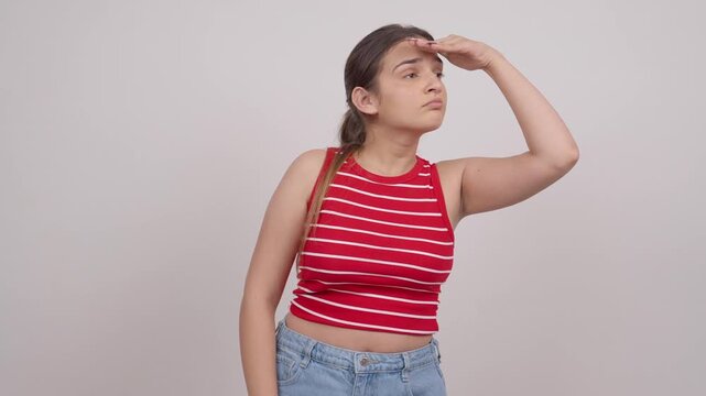 Indian Teenage Girl Looking For Someone with Hand on Forehead