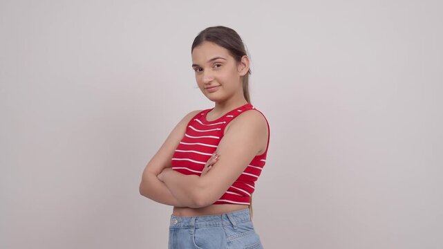 Indian Teenage Girl Turing Around and Smiling with Crossed Arms