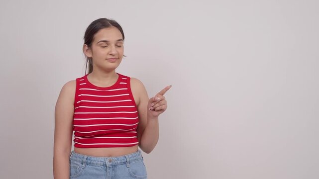 Indian Teenage Girl Pointing at Blank Advertising Space