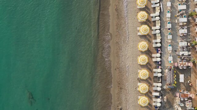 Aerial Video Top View of Beach with Yellow Umbrellas and Clear Water