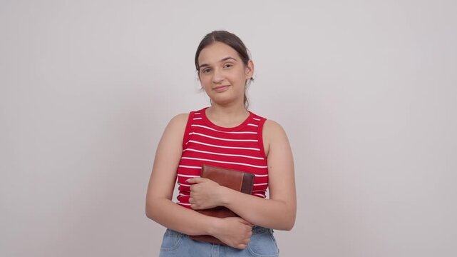 Indian Teenage Girl Smiling Holding Notebook