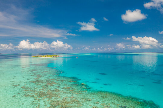 Gorgeous aerial tropical turquoise lagoon vivid coral reef shallow crystal clear water summer island from above. Peaceful summer nature seascape landscape. Drone paradise travel ocean coastal backdrop