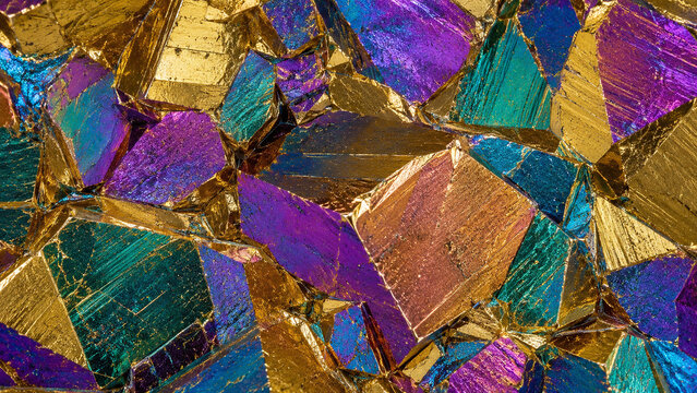 Chalcopyrite crystal macro seamless iridescent tarnish golden-yellow violet blue teal bronze geometric crystal face zones copper iron sulphide background