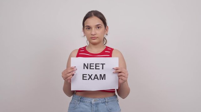 Indian Teenage Girl Holding NEET EXAM Poster
