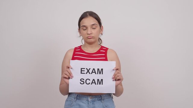 Sad Indian Teenage Girl Holding EXAM SCAM Poster