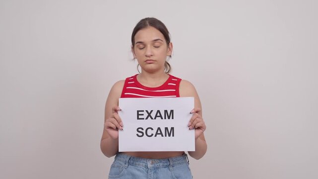 Disappointed Indian Teenage Girl Holding EXAM SCAM Poster