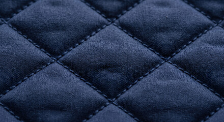 Obraz premium Close up of navy blue quilted fabric with diamond stitching pattern