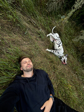Man And Dalmatian Dog Funny Selfie Relaxing In Wild Grass Outdoors
