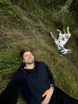 Man And Funny Dalmatian Dog Lying In High Grass Selfie