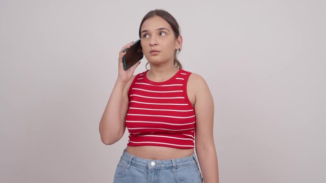 Sad Indian Teenage Girl Talking on Mobile Phone
