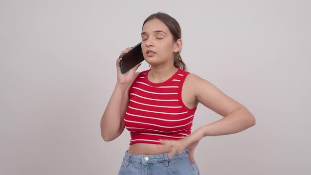 Disappointed Indian Teenage Girl Talking on Mobile Phone