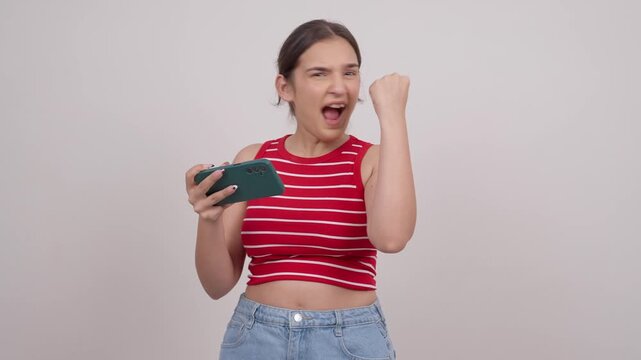 Indian Teenage Girl Playing Game on Phone Winning and Celebrating