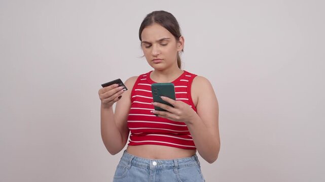 Confused Young Indian Teenager Entering Credit Card Details on a Smartphone
