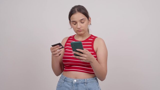 Young Indian Teenager Entering Credit Card Details on a Smartphone for Online Shopping