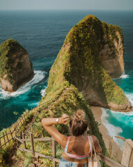 Woman Looking Out at Kelingking Beach Cliff Viewpoint on Nusa Penida, Bali © The Nomad Nextdoor