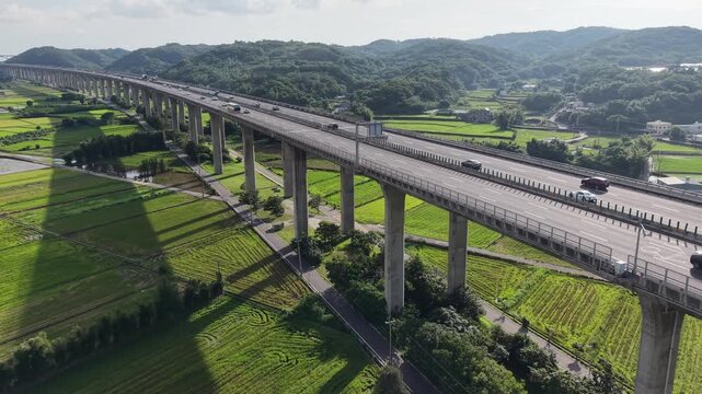Aerial View of Highway Traffic and Elevated Road Through Rural Farmland in Miaoli, Taiwan