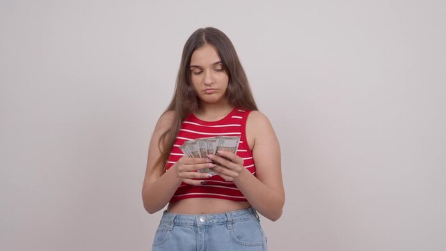 Indian Teenage Girl Counting Money and Smiling at Camera, Indian Rupees